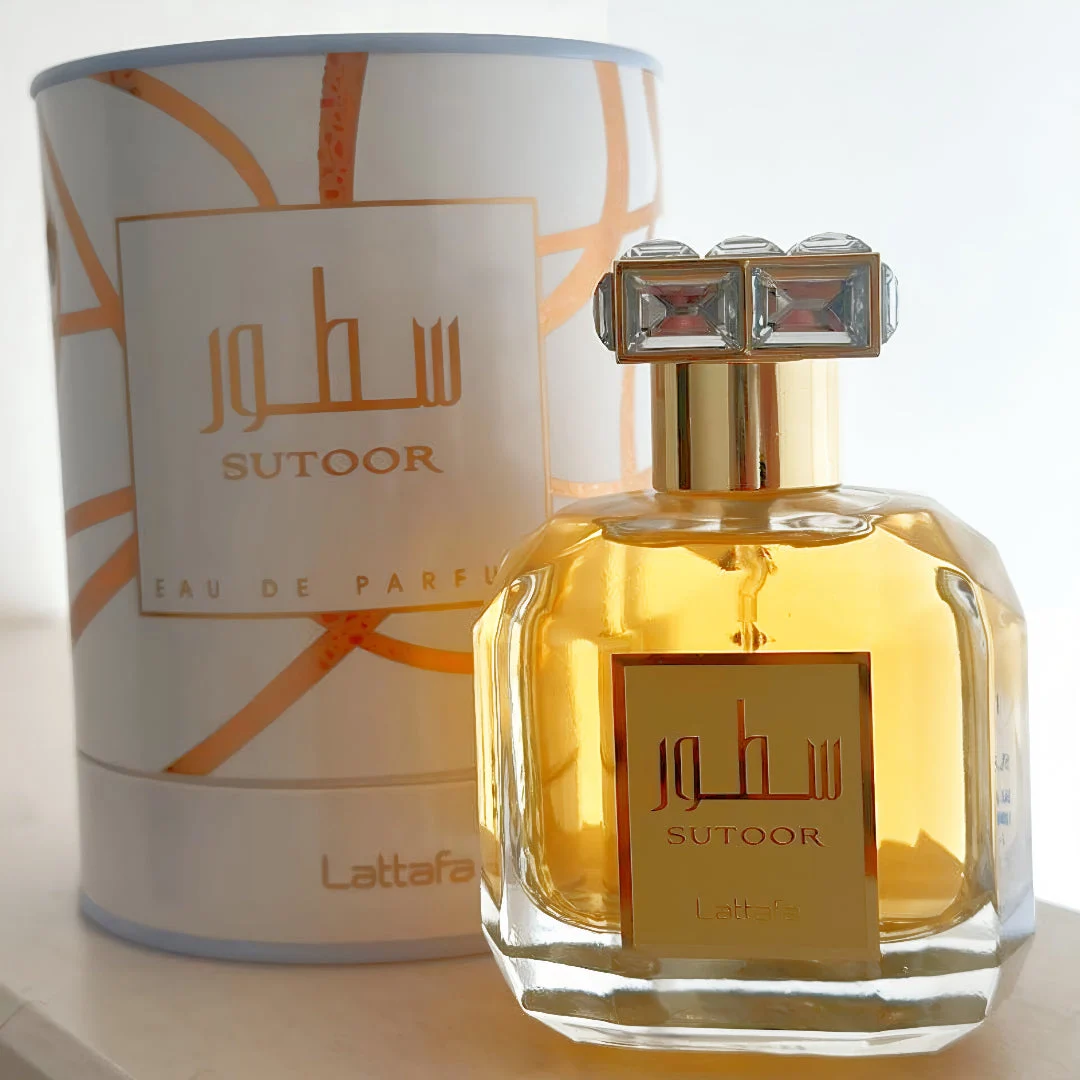 Sutoor Lattafa edp glass bottle yellow with white orange box dark nearby