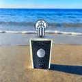 Taweel Lattafa unisex edp on beach sand near ocean waves clear blue sky background closeup