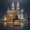Qaed Al Fursan Untamed Lattafa edp perfume bottle and box night dark cityscape Petronas Twin