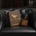 Qaed Al Fursan Untamed Lattafa edp brown packaging next black sofa side table