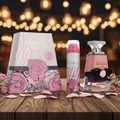 Washwasha Lattafa perfume boxed set wooden table surrounded pink roses petals lights background