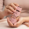 Woman holding pink Yara Elixir Lattafa eau de parfum in hands closeup view