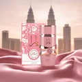Yara Elixir Lattafa pink fragrance on silk cloth in front of city skyline view