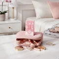 Yara Elixir Lattafa pink packaging on makeup bag surrounded gold accessories white marble tabletop closeup