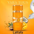 Yara Tous Lattafa orange fragrance spray surrounded fruits yellow background closeup front side