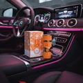 Yara Tous Lattafa orange edp on car console next packaging side view closeup low angle