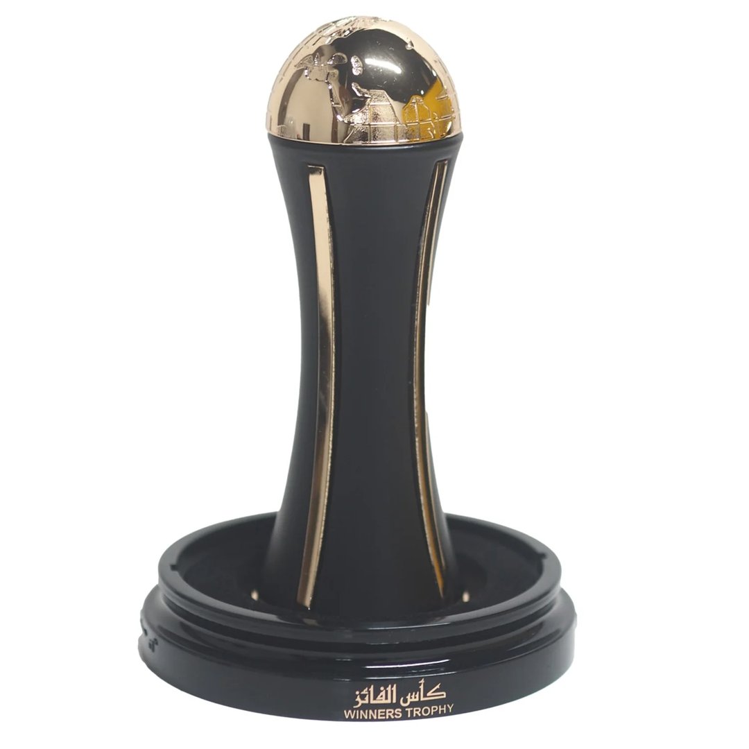 Lattafa Pride Al Khas Winners Trophy Gold 100ml — A dark blue box with gold text and a matching dark blue and gold globe-topped perfume bottle, displayed against a white background. | Lattafa Pride Al Khas Winners Trophy Gold 100ml — Kotak biru gelap dengan teks emas dan botol minyak wangi bertopi dunia biru gelap dan
