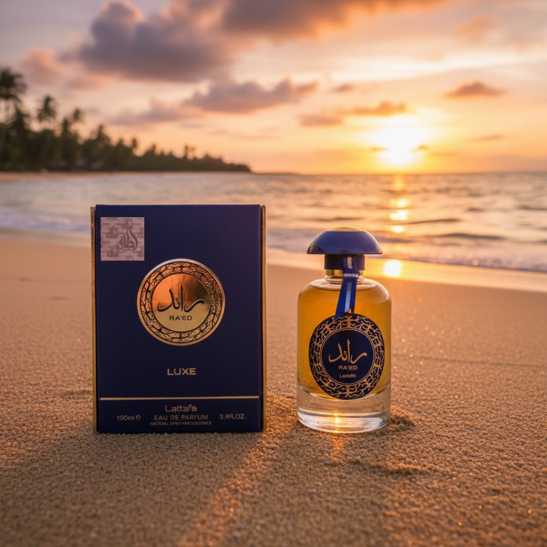 Raed Luxe Lattafa unisex edp on beach sand at sunset golden hour closeup view front