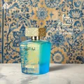 Lattafa Sheikh Al Shuyukh Supreme by Lattafa 100ml — A blue box with Arabic calligraphy and a portrait of a man in a headscarf is next to a clear glass perfume bottle with a gold textured cap and light green liquid. | Lattafa Sheikh Al Shuyukh Supreme by Lattafa 100ml — Kotak biru dengan kaligrafi Arab dan potret