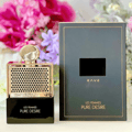Rave Pure Desire Gold edp in black packaging on table beside flowers bouquet closeup view