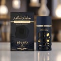 Lattafa Khalta Blend Of Lattafa Eau De Parfum 100ml — A dark blue perfume bottle with a textured, carved outer layer revealing gold accents inside, next to its matching cap with a gold circular emblem. | Lattafa Khalta Blend Of Lattafa Eau De Parfum 100ml — Botol minyak wangi biru gelap dengan lapisan luar bertekstur