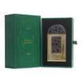Lattafa Pride Maharjan Gold — A gold perfume bottle with a black mosaic cap and decorative panel sits next to its matching dark green embossed box. | Lattafa Pride Maharjan Gold — Botol minyak wangi emas dengan penutup mozek hitam dan panel hiasan duduk di sebelah kotak hijau gelapnya yang bertebuk.