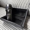 Lattafa Musamam Black Intense 100ml by Lattafa — Black snake coiled around a dark perfume bottle, with a textured black case in the background. | Lattafa Musamam Black Intense 100ml by Lattafa — Ular hitam melilit botol minyak wangi gelap, dengan bekas bertekstur hitam di latar belakang.