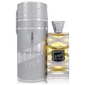 Lattafa Oud Mood Reminiscence 100ml — A cylindrical grey box with silver ornate patterns and a silver ribbon handle stands next to a clear glass perfume bottle with a silver cap, wrapped in white ribbon. | Lattafa Oud Mood Reminiscence 100ml — Kotak kelabu silinder dengan corak perak berhias dan pemegang reben perak