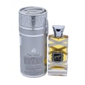 Lattafa Oud Mood Reminiscence 100ml — A cylindrical grey box with silver ornate patterns and a silver ribbon handle stands next to a clear glass perfume bottle with a silver cap, wrapped in white ribbon. | Lattafa Oud Mood Reminiscence 100ml — Kotak kelabu silinder dengan corak perak berhias dan pemegang reben perak