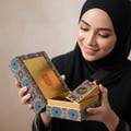 Woman holding Ajwad Lattafa edp unisex perfume boxed gift colorful design closeup