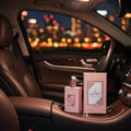 Ameerat Al Arab Prive Rose Lattafa car interior pink boxes display nighttime