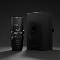 Asad Elixir Lattafa minyak wangi botol hitam sleek latar gelap dekat depan