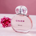 Charm LaMuse Lattafa edp botol atas latar pink dekat mawar merah