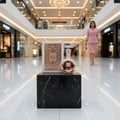 Fakhar Rose Gold Lattafa perfume white packaging black marble stand mall background woman
