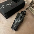 Maahir Black Edition Lattafa perfume sleek glossy packaging wooden table surface closeup