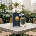 Raed Luxe Lattafa unisex edp on table surrounded green plants outdoor setting Malaysia garden