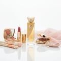 Reve Rose Vurv Lattafa edp gold perfume bottles surrounded makeup accessories pink cloth