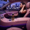Teriaq Intense Lattafa on car console woman wearing black dress sitting inside vehicle at night