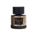 Lattafa Tamima 100ml Eau de Parfum — A black perfume bottle with a wooden cap and a rose gold label sits next to its matching black textured box with rose gold Arabic calligraphy and text. | Lattafa Tamima 100ml Eau de Parfum — Botol minyak wangi hitam dengan penutup kayu dan label emas mawar duduk bersebelahan dengan